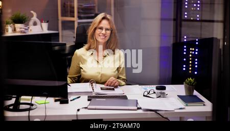 Professional Woman with a Smile, Consulting in Office as Accountant and Advisor at Work Stock Photo