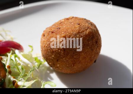 Tasty italian street food, deep fried aranchini rice balls with different filling close up Stock Photo