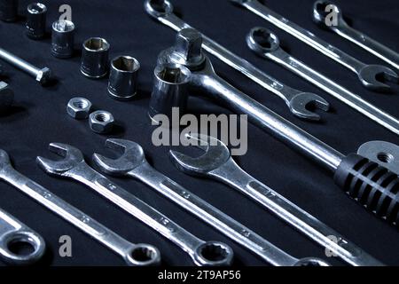 Steel Shiny Set Of Spanners, Sockets, Quick Release Ratchet And Hardware Items Laid Out In Order On Black Surface Stock Photo