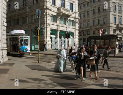 tourists walking in Piazza Cordusio square, Milan, Lombardy, Italy Stock Photo
