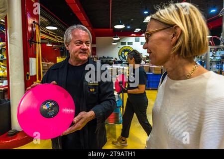 Production manager Eddie Gillis shows off a freshly pressed record at the vinyl pressing plant of the record label Third Man Records / Third Man Pressing. Customers can choose from a wide range of designs. Production site of the record label Third Man Records / Third Man Pressing in Detroit, United States. Third Man Pressing's vinyl manufacturing plant is located in Detroit's Cass Corridor.. Vinyl pressing production facility of the record label Third Man Records / Third Man Pressing Stock Photo