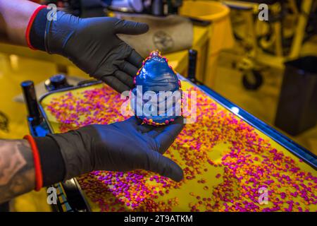 The pre-tempered vinyl puck can be coated with coloured granulate before the record is pressed. Vinyl pressing production facility of the record label Third Man Records / Third Man Pressing Production site of the record label Third Man Records / Third Man Pressing in Detroit, United States. Third Man Pressing's vinyl manufacturing plant is located in Detroit's Cass Corridor.. Vinyl pressing production facility of the record label Third Man Records / Third Man Pressing Stock Photo