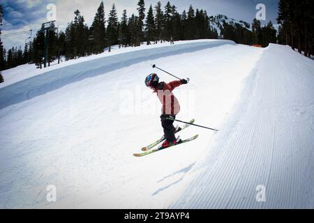 Young skier dropping into a half pipe. Stock Photo