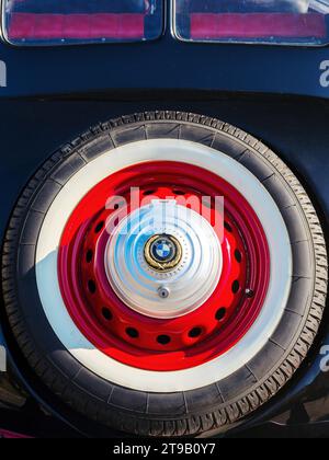 uzhgorod, ukraine - 31 oct 2021: rear close-up of a red bmw 321 oldtimer. spare wheel with mascot on the trunk Stock Photo