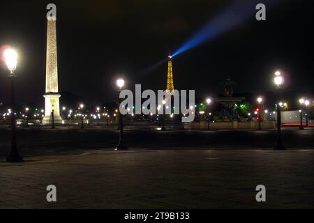 Paris, France - August 22 2005: Place de la Concorde with the Luxor Obelisk and the Fountain of Rivers with the Eiffel Tower behind at night. Stock Photo