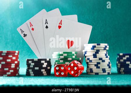 Background with cards chips and dices for playing casino gambling on green felt mat and green isolated background. Front view. Stock Photo