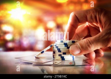 Hand betting with chips on table with ace cards in gambling hall. Front view. Stock Photo