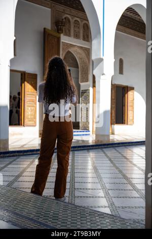 (Selective focus) Stunning view of a tourist taking a photo at the Bahia Palace during a sunny day. Stock Photo