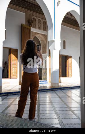 (Selective focus) Stunning view of a tourist taking a photo at the Bahia Palace during a sunny day. Stock Photo