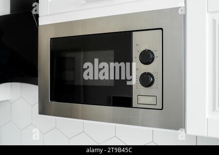 Modern kitchen view of built-in metal microwave oven Stock Photo