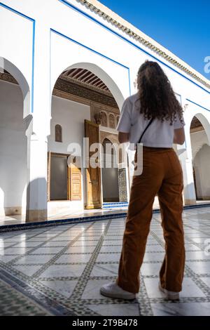 Stunning view of a girl visiting the Bahia Palace during a sunny day. The Bahia Palace in Marrakech is an impressive example of Moroccan architecture Stock Photo