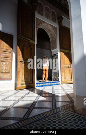 Stunning view of a girl visiting the Bahia Palace during a sunny day. The Bahia Palace in Marrakech is an impressive example of Moroccan architecture Stock Photo