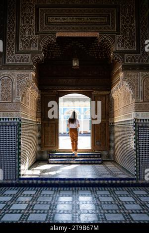 Stunning view of a girl visiting the Bahia Palace during a sunny day. The Bahia Palace in Marrakech is an impressive example of Moroccan architecture Stock Photo