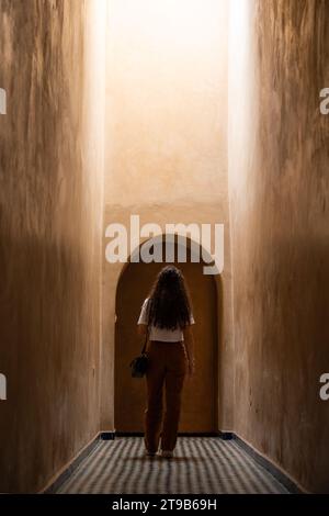 Stunning view of a girl visiting the Bahia Palace during a sunny day. The Bahia Palace in Marrakech is an impressive example of Moroccan architecture Stock Photo