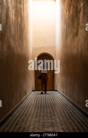 Stunning view of a girl visiting the Bahia Palace during a sunny day. The Bahia Palace in Marrakech is an impressive example of Moroccan architecture Stock Photo