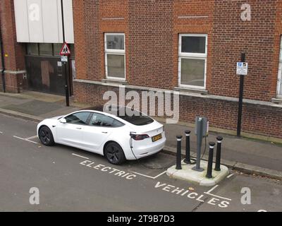 On street vehicle charging points in Leyton, London, UK. A Tesla car connected to a council-run electric vehicle charging point. Stock Photo
