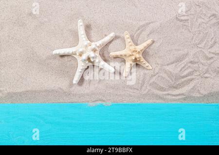 Starfishes on the sand wooden board top view Stock Photo