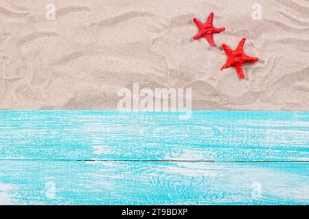 Summer concept - red starfish on the sand top view Stock Photo