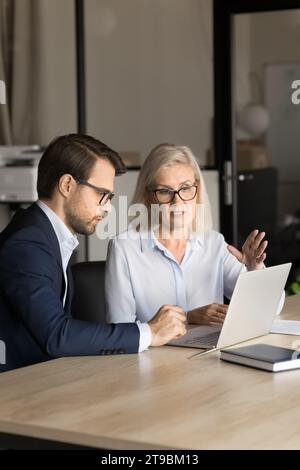 Confident business colleagues couple analyzing online project content Stock Photo