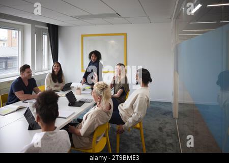 Diverse team having business meeting in conference room Stock Photo