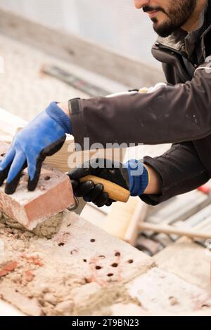 Bricklayer working on construction site Stock Photo