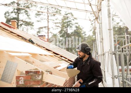 Bricklayer working on construction site Stock Photo