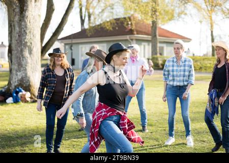 Woman dancing together in park Stock Photo