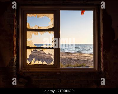 View on sea from abandoned house window Stock Photo
