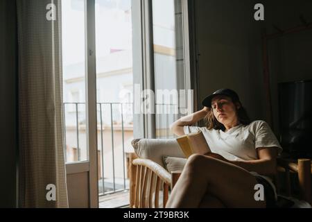 Woman relaxing at home reading book Stock Photo