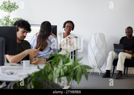 People sitting and using computers in office Stock Photo