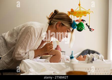 Side view of happy woman spending leisure time with son at home Stock Photo