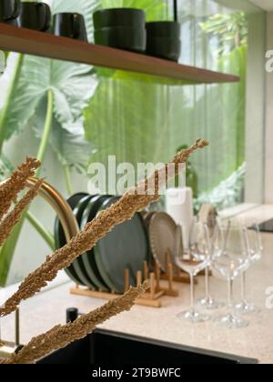 Dried decorative grass closeup with blured kitchen interior on on background Stock Photo