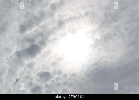 Bright Sunbeam Shining Among Fluffy Altocumulus Clouds Stock Photo