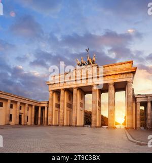 Brandenburg Gate in Berlin, Germany at sunset with Sun shining through the gate Stock Photo