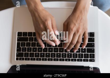 Top view unknown female hands typing on laptop keyboard Stock Photo