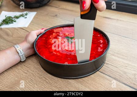 Sponge cake with custard cream and strawberries covered with jelly on top. Stock Photo