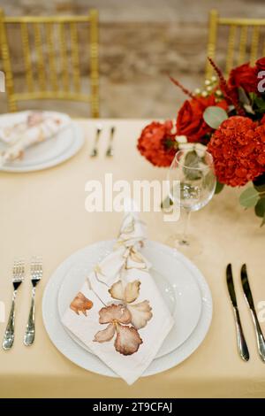Knotted napkin lies on a plate on a festive table Stock Photo