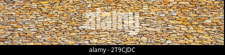 Earthy Elegance: Stone Slate Wall in Warm Tones Stock Photo