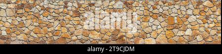 Rugged Charm: Stone Slate Wall Bathed in Natural Light Stock Photo