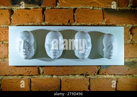 white mannequin head, Faceless, red brick wall and white wood floor. Stock Photo