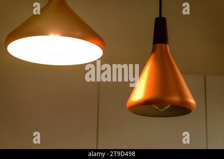 Decorative electric lamps hanging on the ceiling. Stock Photo