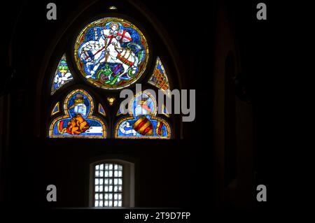 MALBORK, POLAND - 6 NOVEMBER 2023: Stained glass window depicting  St George slaying the dragon  in world's largest castle, once the seat of the grand Stock Photo