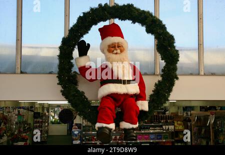 A view of Father Christmas swinging to and fro, above the entrance to the Lytham St Annes Garden Centre, Lancashire, United Kingdom, Europe Stock Photo