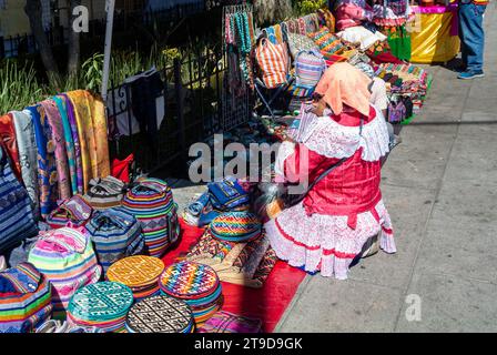 Mexico City, CDMX, Mexico, Ingenious woman with traditional mexican costume selling souvenirs in Coyoacan neighborhood. Editorial only. Stock Photo