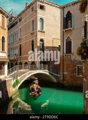 Tourists taking gondola ride in Venice city, Italy Stock Photo