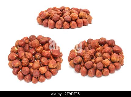Set of handfuls of nuts from different angles - peeled ripe hazelnuts closeup, isolated on white background Stock Photo