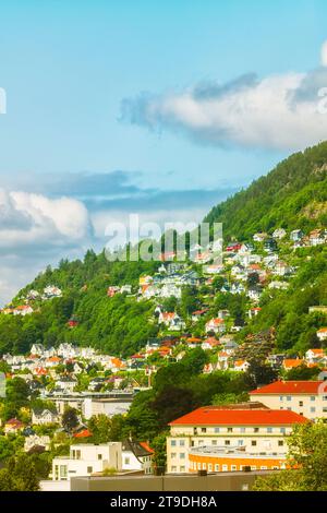 Homes and businesses built on the side of a mountain, photographed during a summer afternoon at the city of Bergen, Norway. Stock Photo