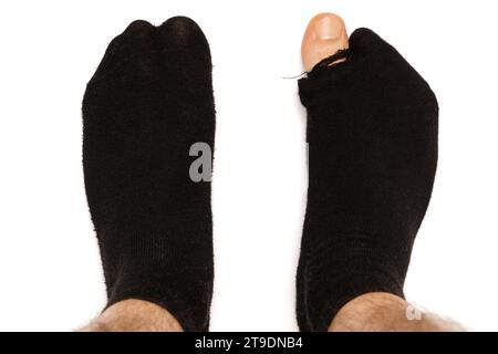 Poority concept image. Woman in socks with holes Stock Photo - Alamy
