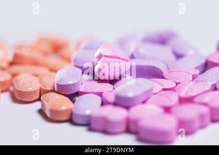 Closeup shot of a pile of colorful vitamin pills on white background. Stock Photo