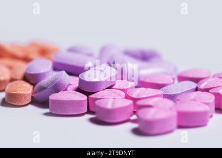 Closeup shot of a pile of colorful vitamin pills on white background. Stock Photo